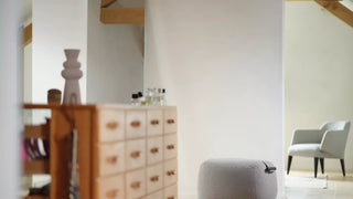 Photo d'ambiance d'un pouf et d'un fauteuil Mobitec Thalia gris dans un grenier lumineux avec commode