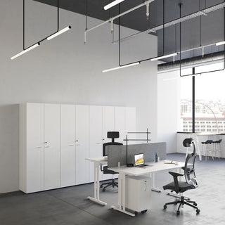 Lifestyle image of a white Buronomic Comfort slim pedestal next to a desk and white cabinets