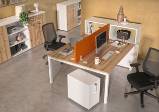 Lifestyle image of a white Buronomic Comfort slim pedestal by a twin workstation with orange screen