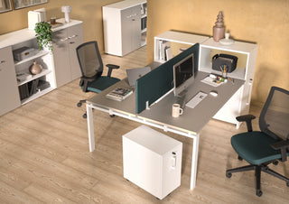 Lifestyle image of a white Buronomic Comfort slim pedestal by a twin workstation, seen from above