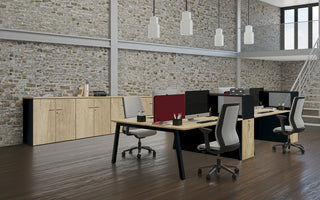 Lifestyle image of Buronomic Optimax EVO tower pedestals in black and Nebraska by a brick wall