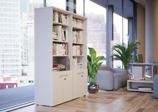 Lifestyle image of a white Buronomic Quietude bookcase by large windows with city view
