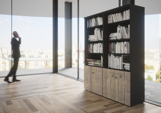 Lifestyle image of a Buronomic Quietude bookcase in black and Timber by a glass facade