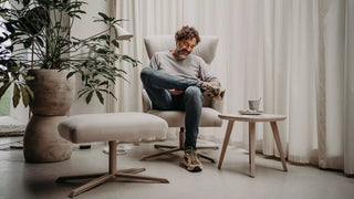 Photo d'ambiance d'un homme dans un fauteuil Mobitec Enora clair avec repose-pieds